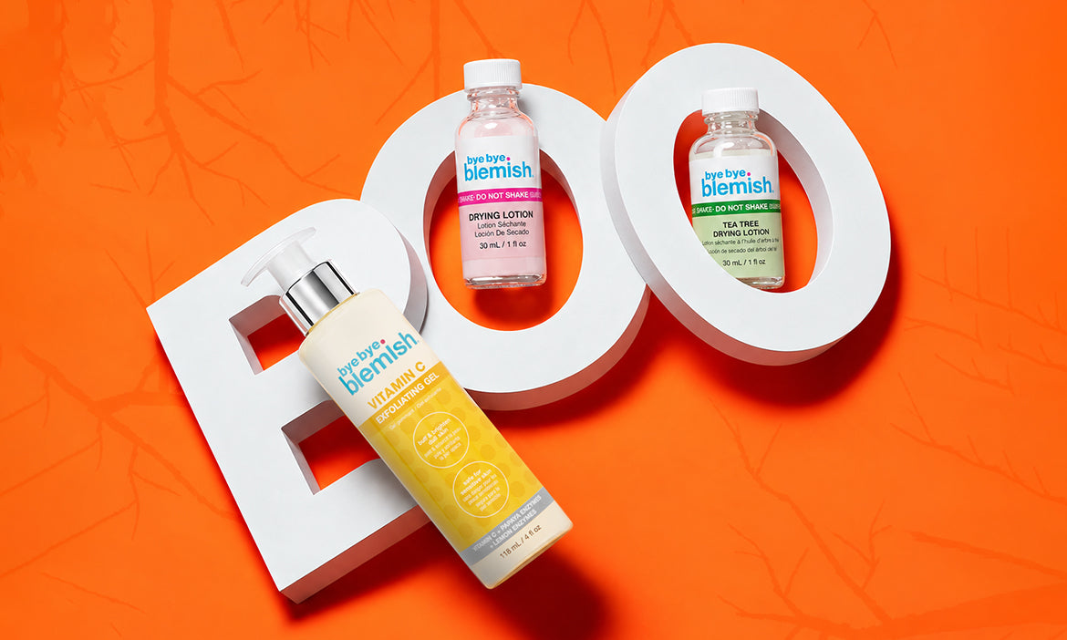 Bye Bye Blemish skincare products displayed against an orange Halloween-themed background, featuring Vitamin C exfoliating gel and two drying lotions.