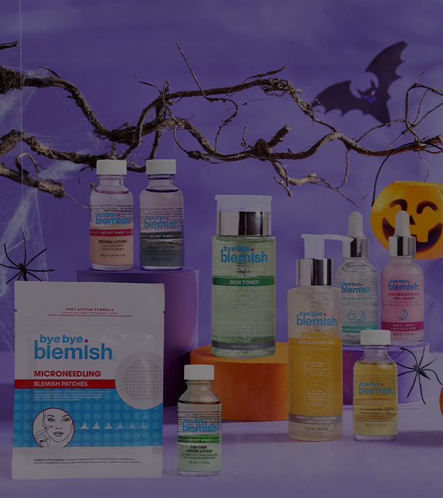 Bye Bye Blemish skincare products on a purple background with Halloween decorations.