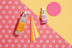 Skin Resurfacing Peel Serum bottle next to Vitamin C bottle