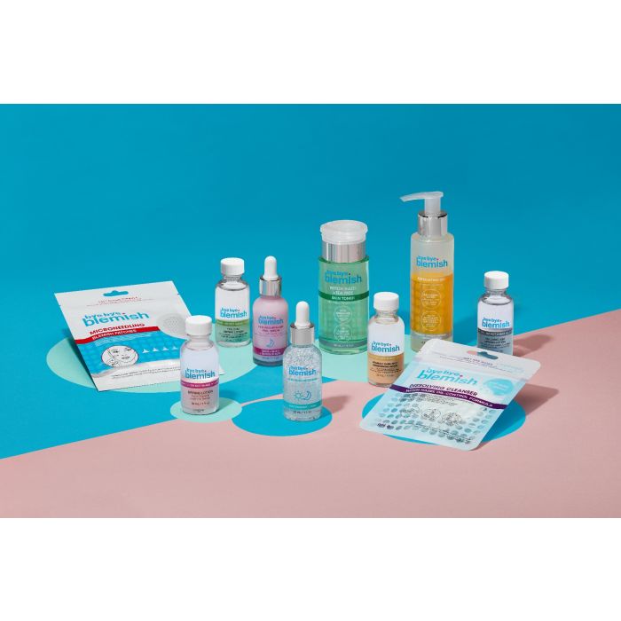 Complete Bye Bye Blemish Skincare Line – Full lineup of acne treatments and skincare products arranged on a vibrant blue background.