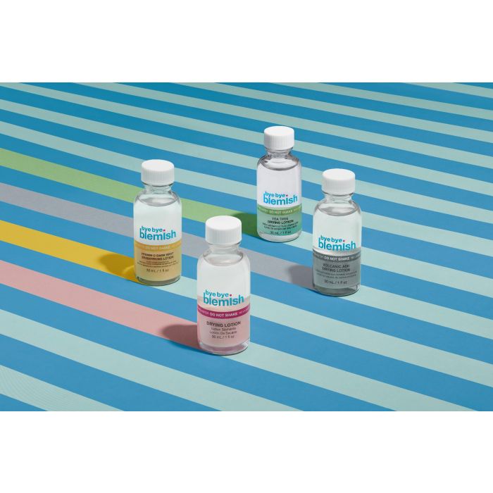 Bye Bye Blemish Skincare Collection – A variety of acne-fighting skincare products displayed on a colorful striped background.