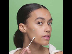 Woman applying acne spot treatment – Skincare routine with acne spot corrector for clear complexion.